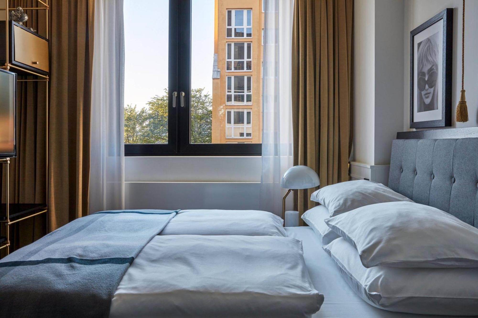 ホテル ルームス ミューニック オートグラフ コレクション ミュンヘン エクステリア 写真 A bedroom at the hotel